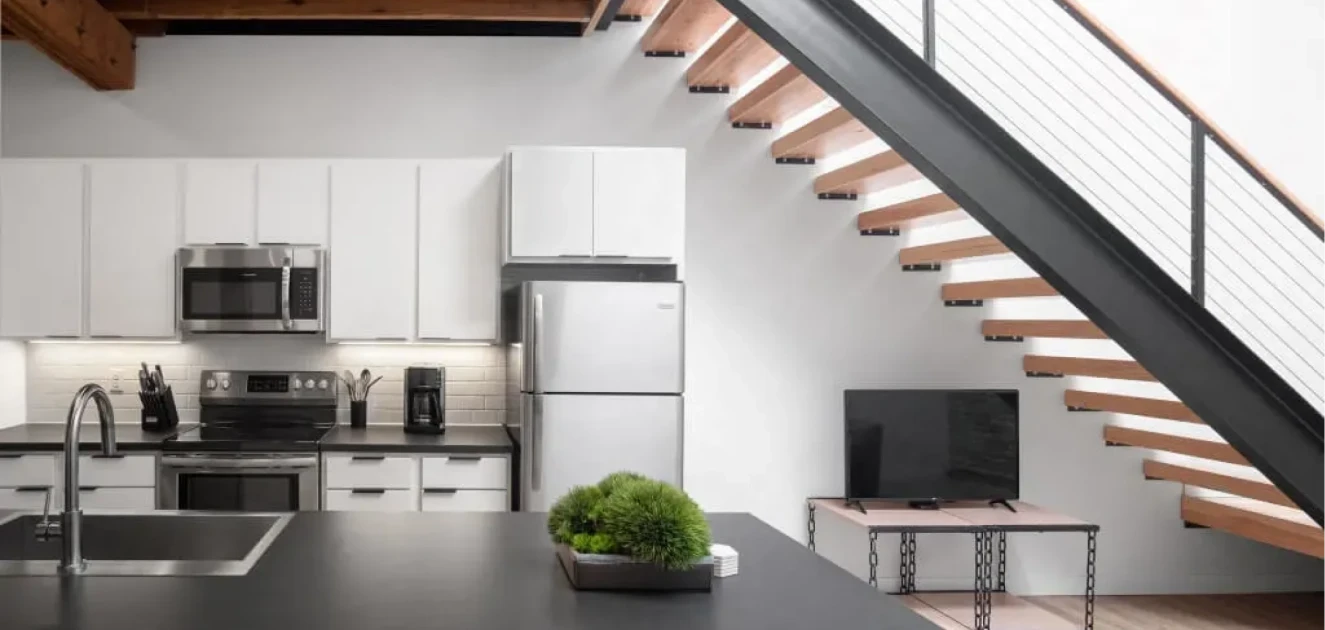 Bostad apartment features a kitchen with a staircase