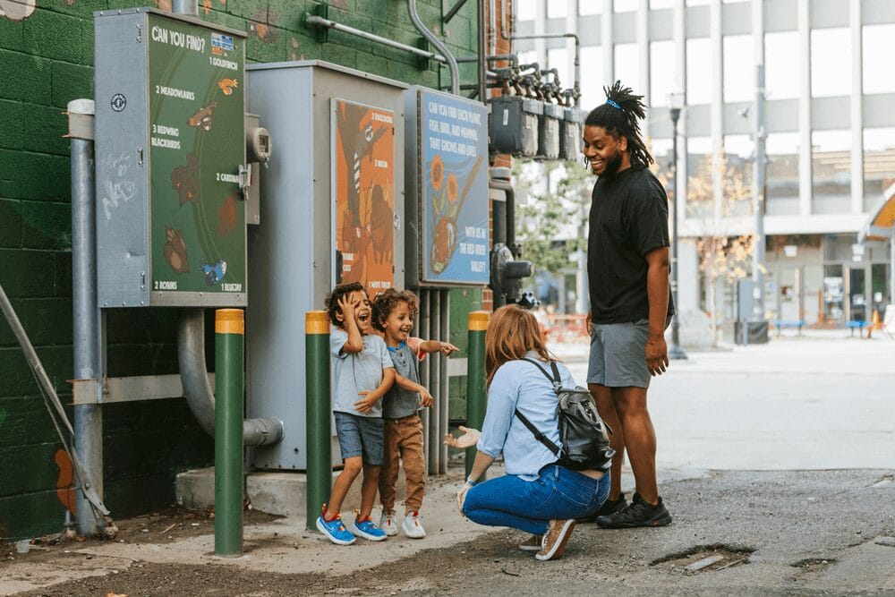 a group of children standing on the sidewalk.