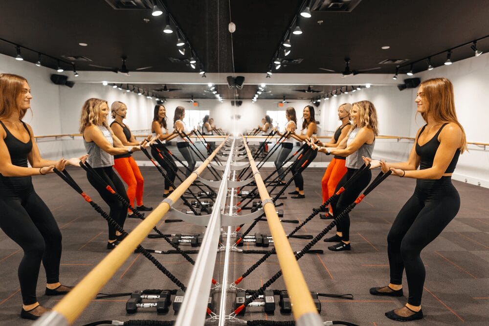 a group of women working out in a gym.
