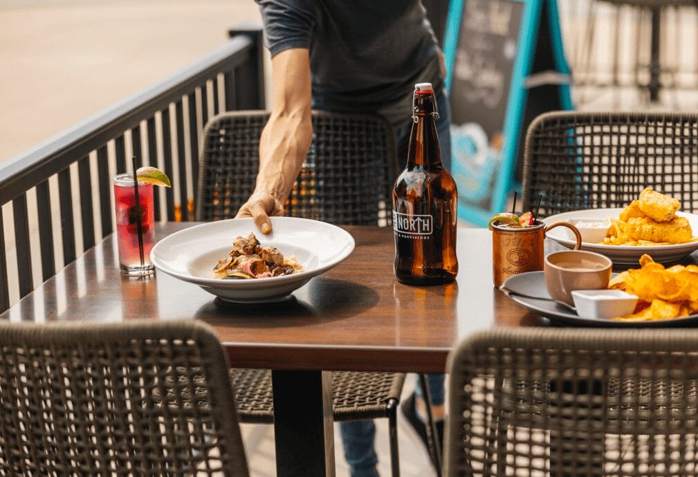 a person reaching for food on a table.