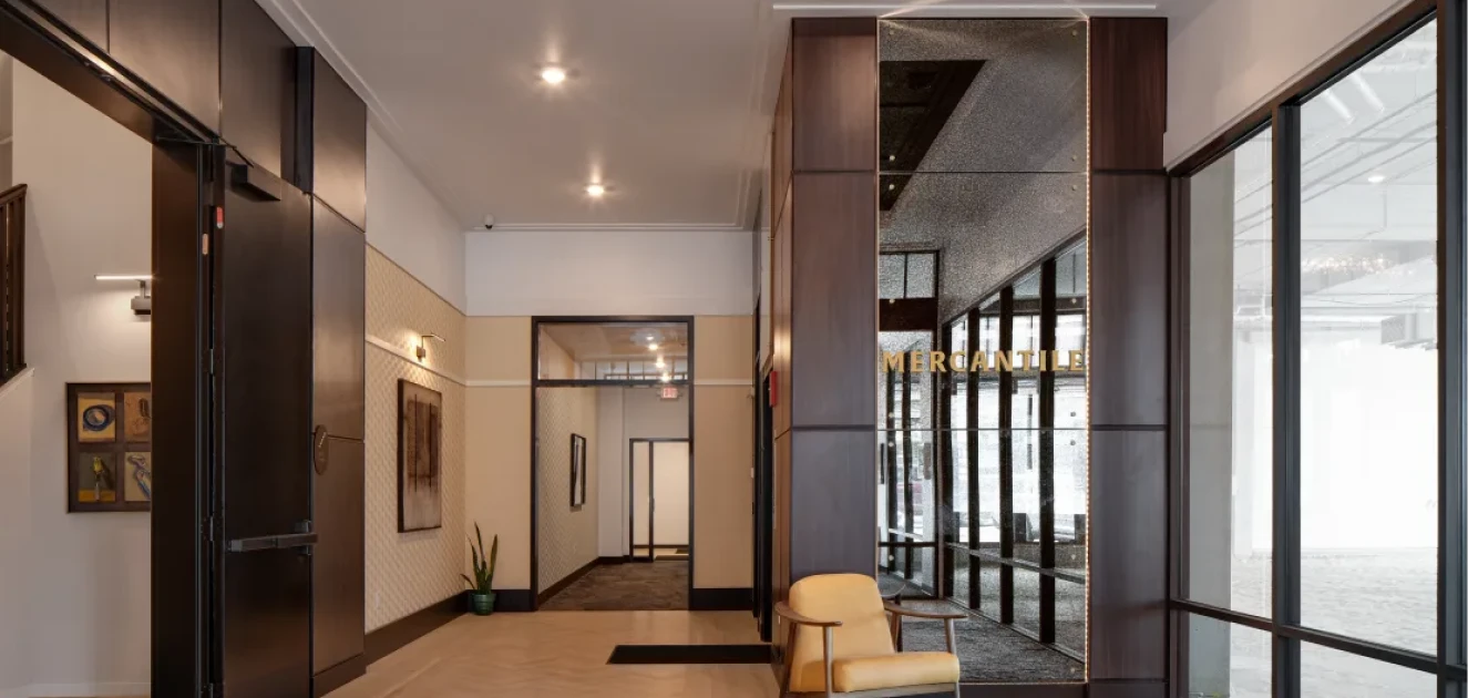 a glass wall with a chair in front of it.