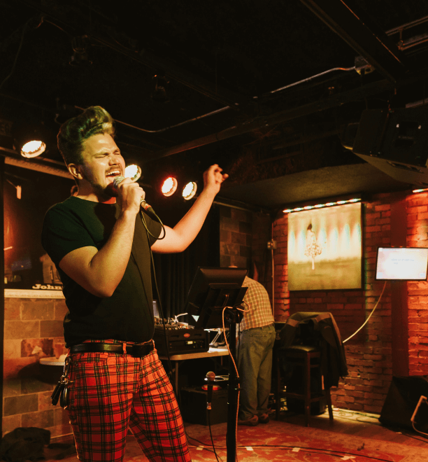 a man singing into a microphone.