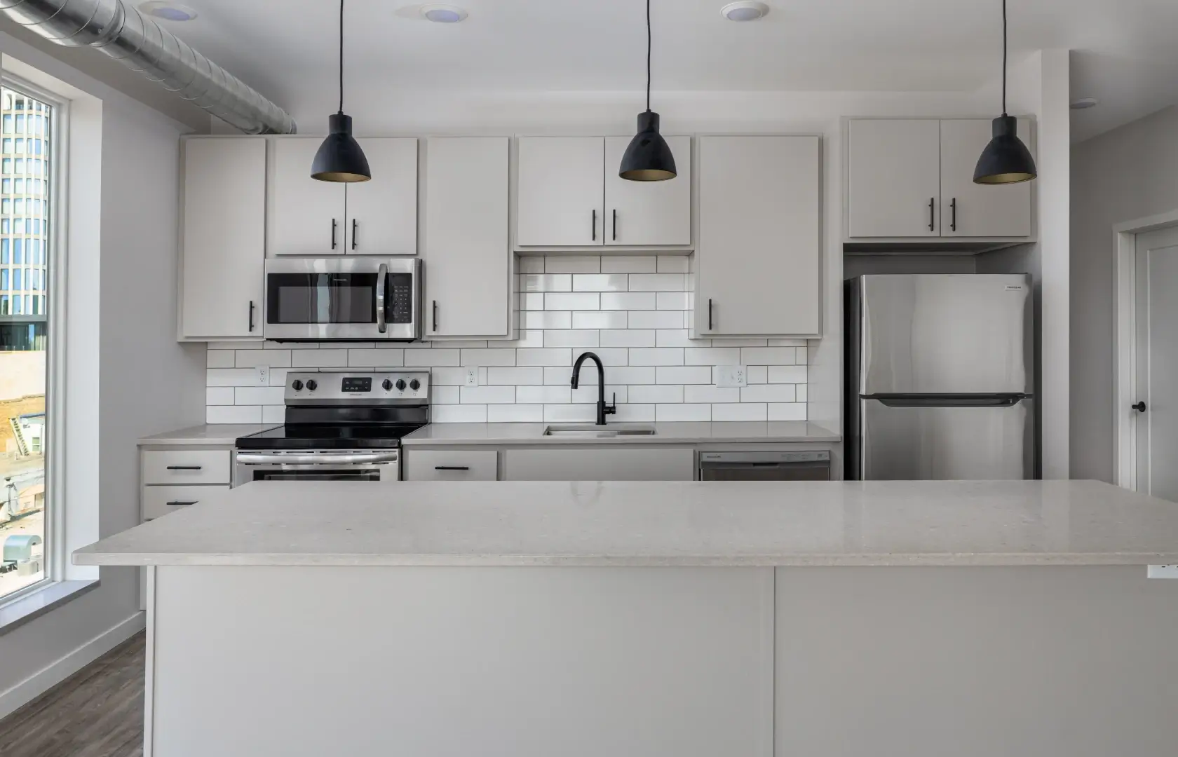 a kitchen with white cabinets and a white counter top.