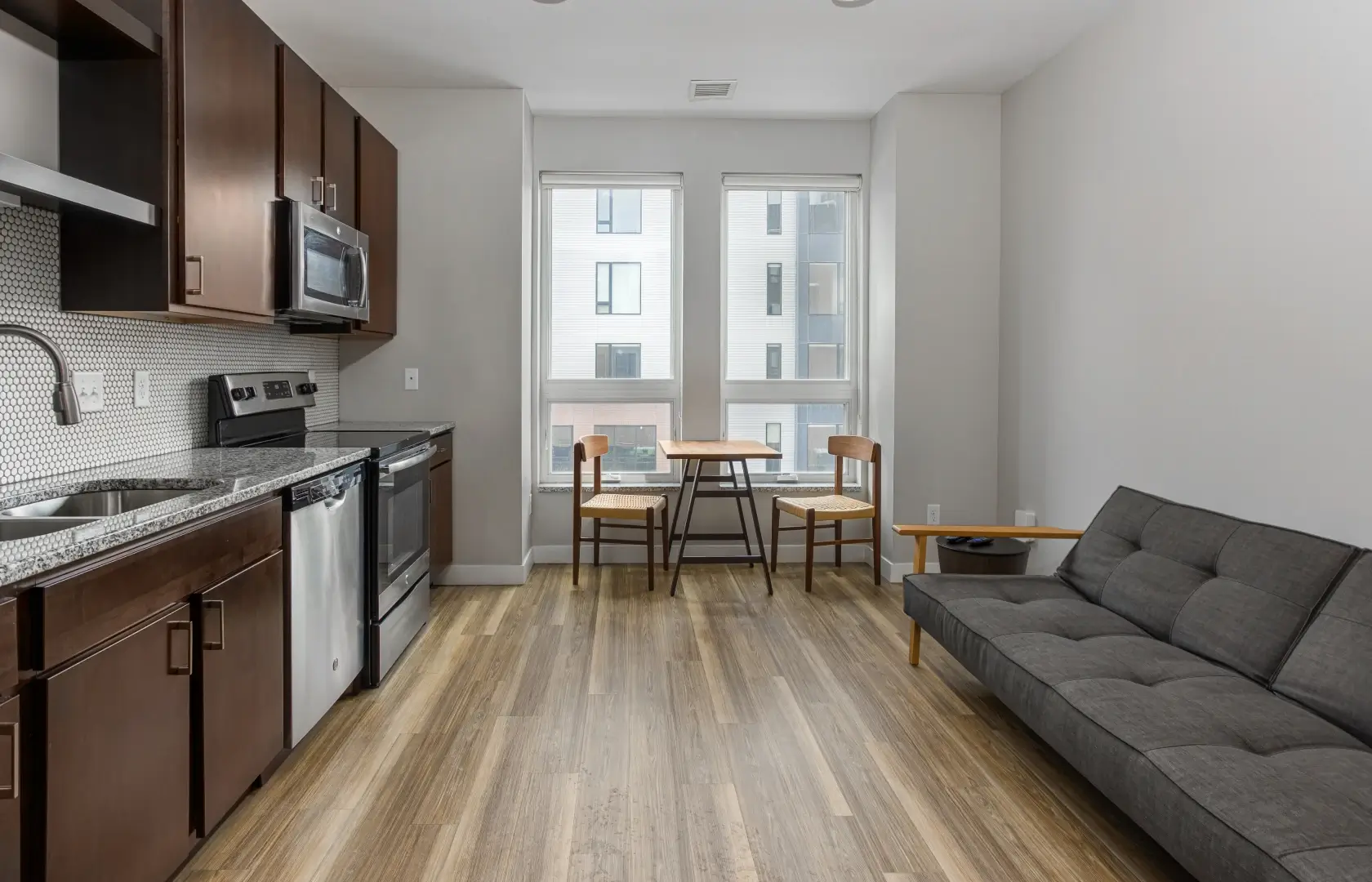 Roco apartment features a living room with a couch and a kitchen.