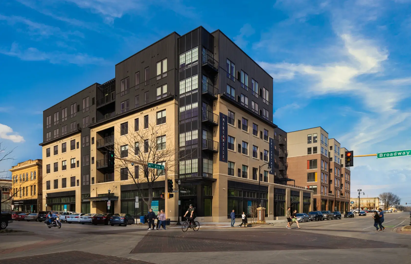 Mercantile apartment building with people walking on the street.